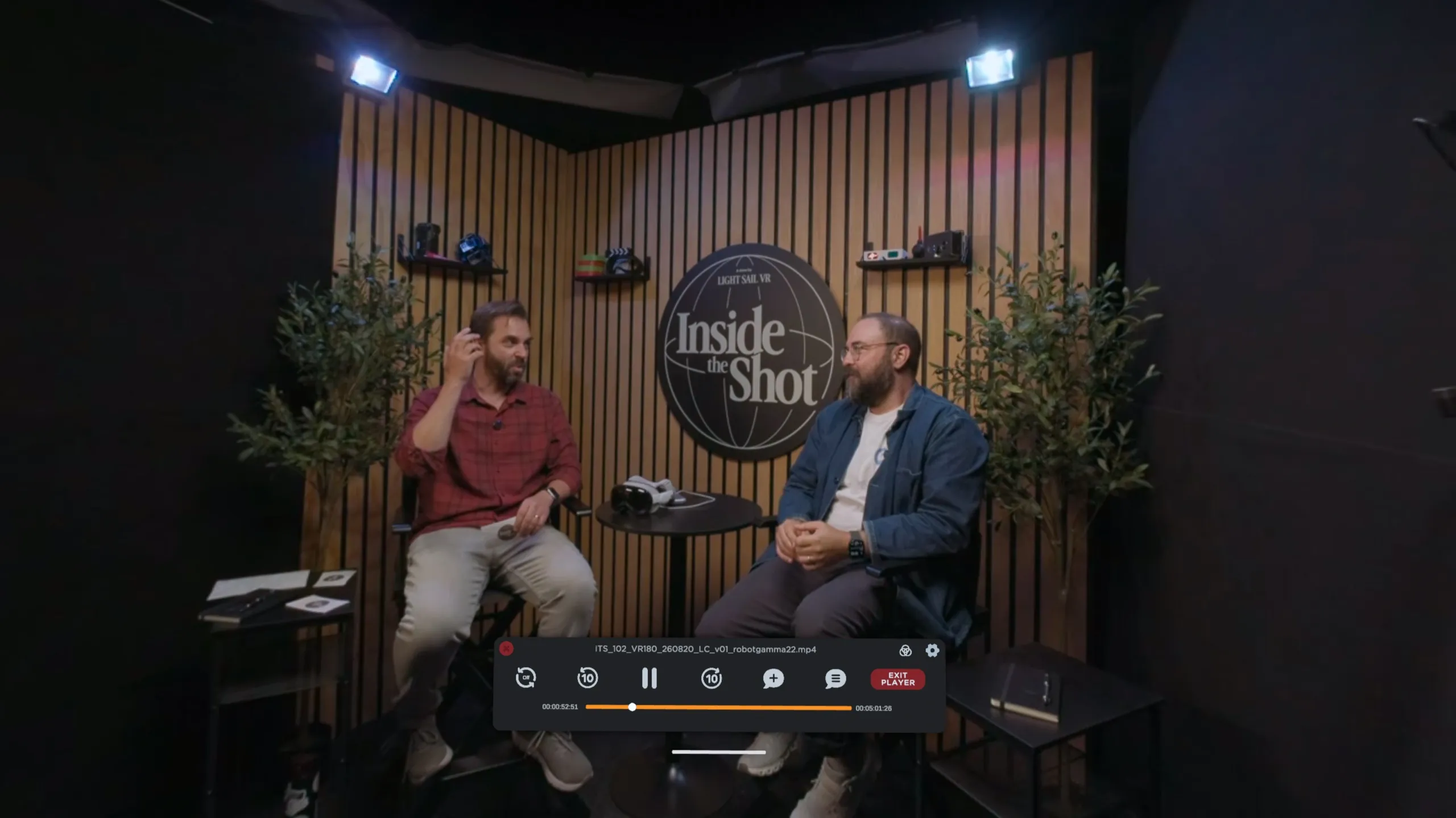 Screening Room playing a 180° interview recorded on a studio set, with the transport bar below the two speakers.